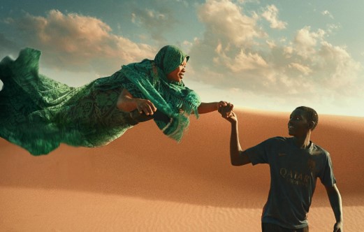 A man holding a woman by the hand who appears to be floating in the air